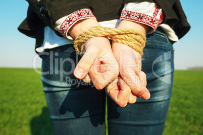 Hands tied up with rope