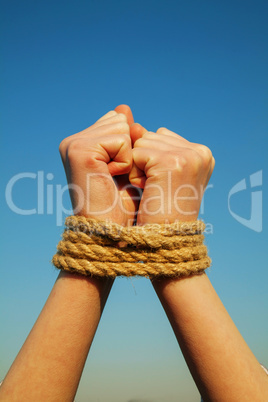 Hands tied up with rope