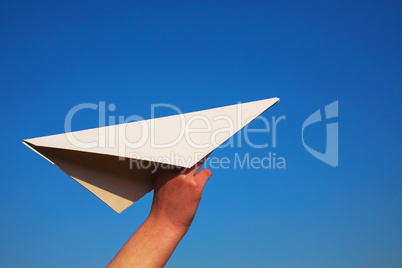 Hand holding paper plane