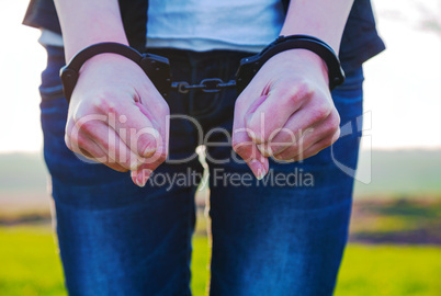 Handcuffed woman hands