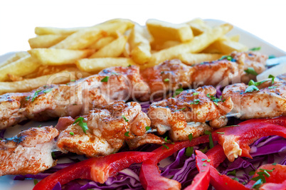 Meat grilled on skewers with chips