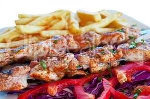 Meat grilled on skewers with chips