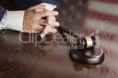 Judge Rests Hands Behind Gavel with American Flag Table Reflecti