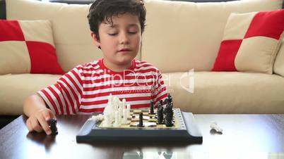 Little boy learning how to play chess