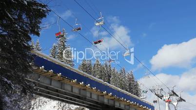 Ski Lifts Moving Over Bridge In Mountains