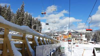 Ski Lifts Moving Over Bridge And Houses