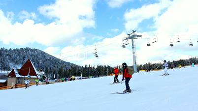Skiers On Easy Track In Mountains
