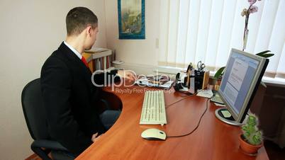 Man On Phone Taking Notes At Work