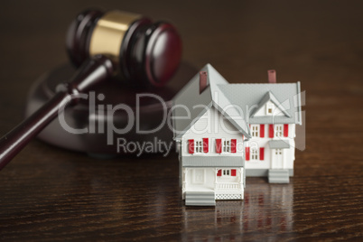 Gavel and Small Model House on Table