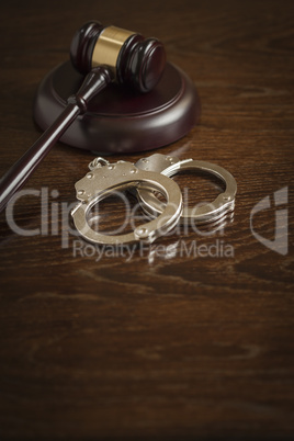 Gavel and Pair of Handcuffs on Table