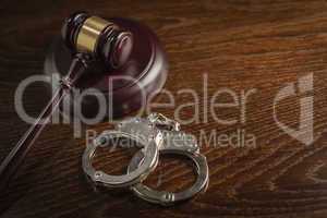 Gavel and Pair of Handcuffs on Table