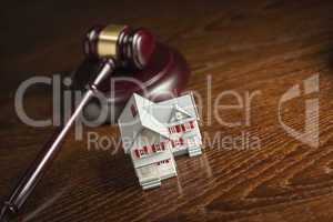 Gavel and Small Model House on Table