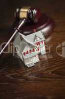 Gavel and Small Model House on Table