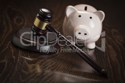 Gavel and Piggy Bank on Table