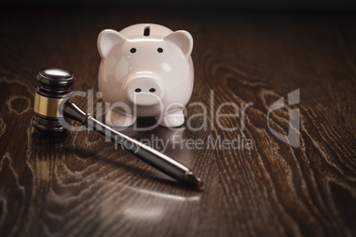 Gavel and Piggy Bank on Table