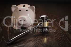 Gavel and Piggy Bank on Table