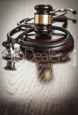 Gavel and Stethoscope on Reflective Table