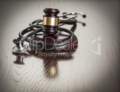 Gavel and Stethoscope on Reflective Table