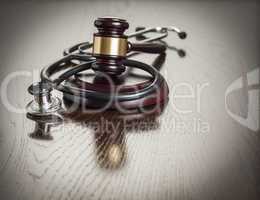 Gavel and Stethoscope on Reflective Table