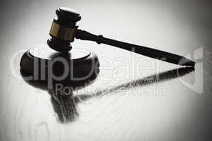 Dramatic Gavel Silhouette on Reflective Wood