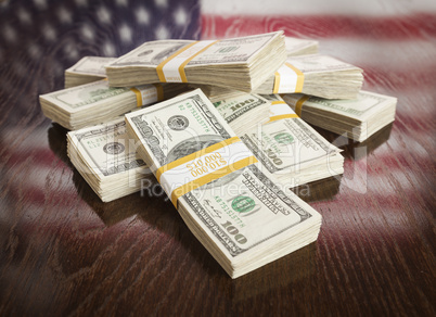 Thousands of Dollars with Reflection of American Flag on Table