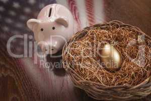 Golden Egg, Nest and Piggy Bank with American Flag Reflection