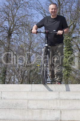 Cyclist is riding his bike on the stairs