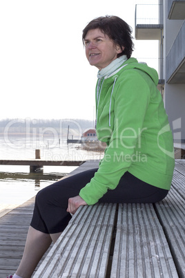 Woman sitting by the lake