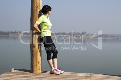 Woman on the jetty enjoying the spring sun