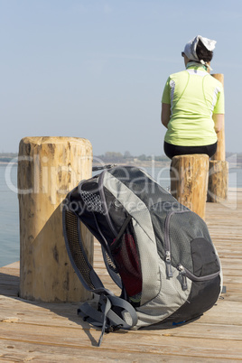 Woman sitting on the boat dock and resting from the hike from