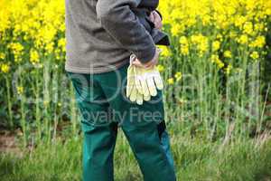 Farmer with work gloves prior rape field