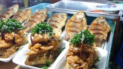 Stall selling Num Tok Phla (tilapia fish) at a market, Chiang Mai, Thailand.