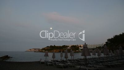 Sunbeds on the beach at luxury hotel during sunset, Crete, Greece