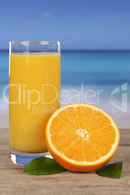 Frischer Orangensaft und Orangen am Strand