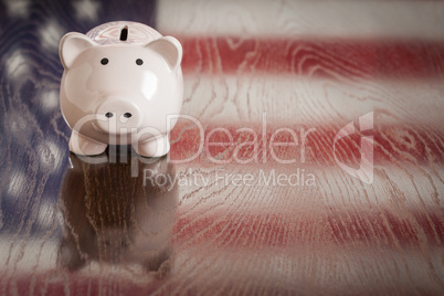 Piggy Bank with an American Flag Reflection on Table