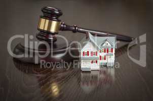 Gavel and Small Model House on Table