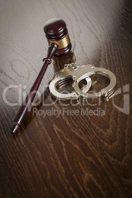 Gavel and Pair of Handcuffs on Table