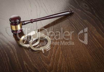 Gavel and Pair of Handcuffs on Table