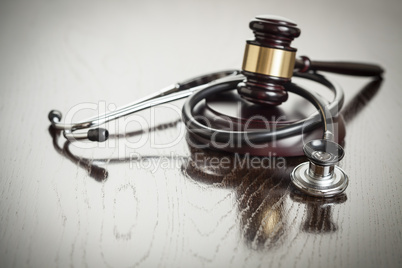 Gavel and Stethoscope on Reflective Table