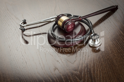 Gavel and Stethoscope on Reflective Table