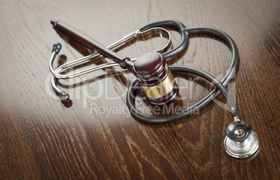 Gavel and Stethoscope on Reflective Table