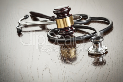 Gavel and Stethoscope on Reflective Table