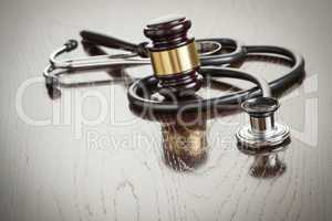 Gavel and Stethoscope on Reflective Table