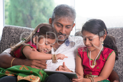 indian family using tablet computer.