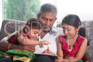 indian family using tablet computer.