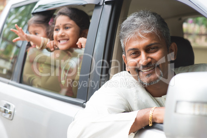indian father driving new car.