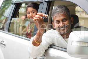 indian man showing his new car key.