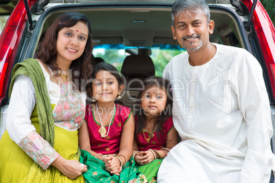 indian family sitting in car.