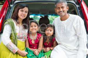 indian family sitting in car.