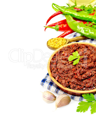 Adjika with hot pepper and spices on napkin
